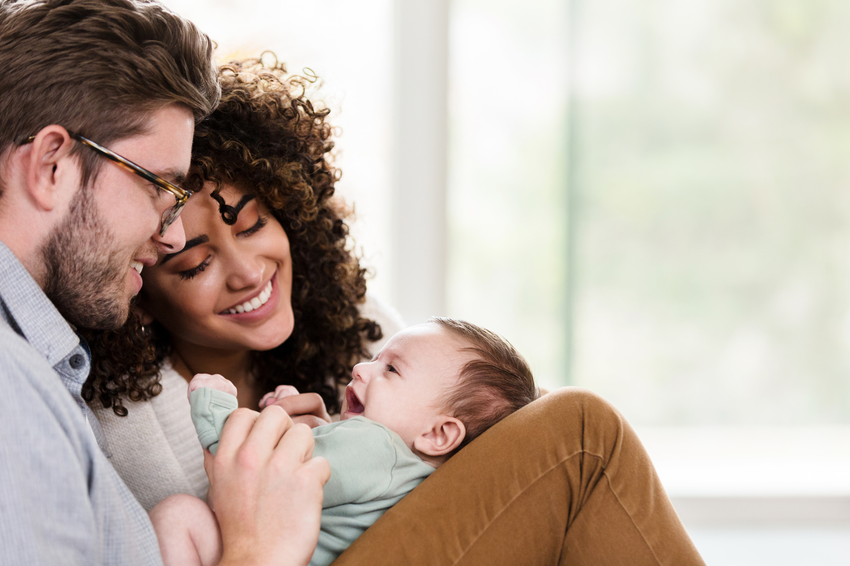Adorable young family with newborn